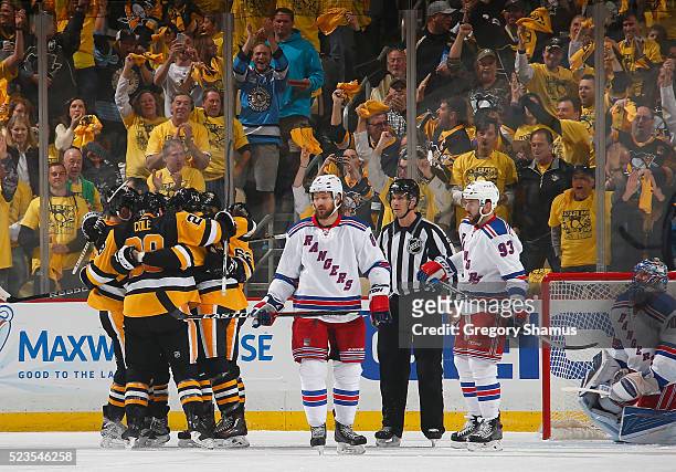 Carl Hagelin of the Pittsburgh Penguins celebrates his goal with teammates in front of Kevin Klein and Keith Yandle of the New York Rangers in Game...