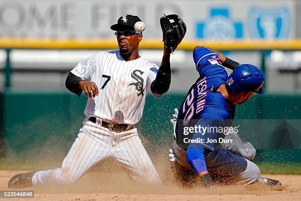 Ian Desmond of the Texas Rangers steals second base as Jimmy Rollins of the Chicago White Sox is unable to make the catch during the seventh inning...