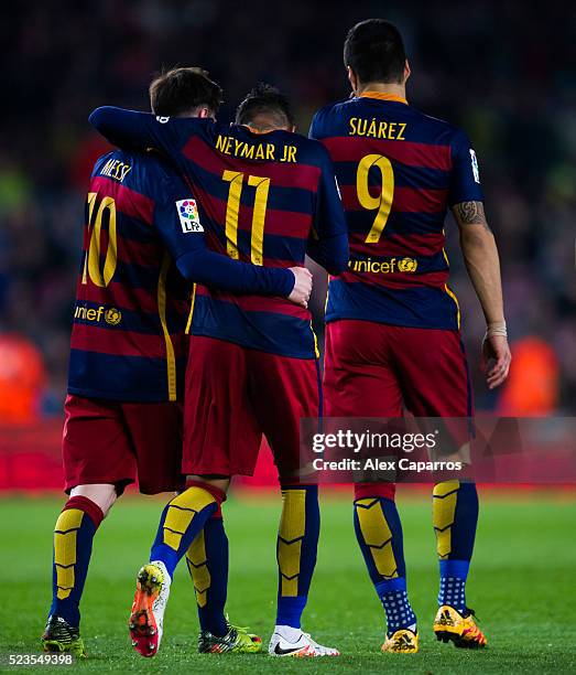 Neymar Santos Jr of FC Barcelona is congratulated by his teammates Luis Suarez and Lionel Messi after scoring his team's fifth goal during the La...
