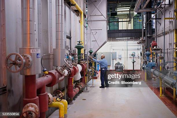 Worker inspects boilers at the Enwave Energy Corp. Steam plant in Toronto, Ontartio, Canada, on Friday, April 8, 2016. Enwave Energy Corp. Provides...