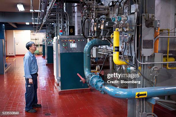 Worker inspects boilers at the Enwave Energy Corp. Steam plant in Toronto, Ontartio, Canada, on Friday, April 8, 2016. Enwave Energy Corp. Provides...