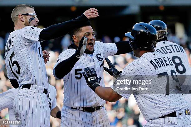 Brett Lawrie of the Chicago White Sox and Melky Cabrera celebrate with Jose Abreu after he hit a walkoff RBI single against the Texas Rangers during...