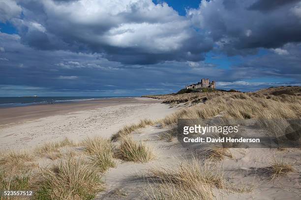 cloud over castle - northumberland stock pictures, royalty-free photos & images