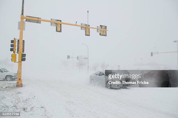 winter storm driving intersection - snow storm stock pictures, royalty-free photos & images