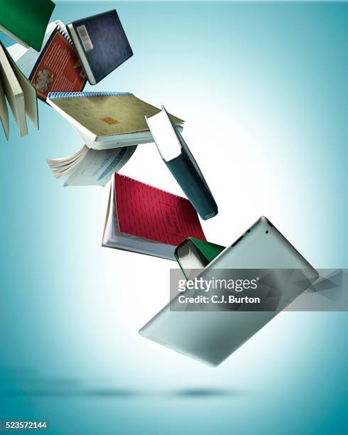 tablet and books on blue background - ereader stockfoto's en -beelden