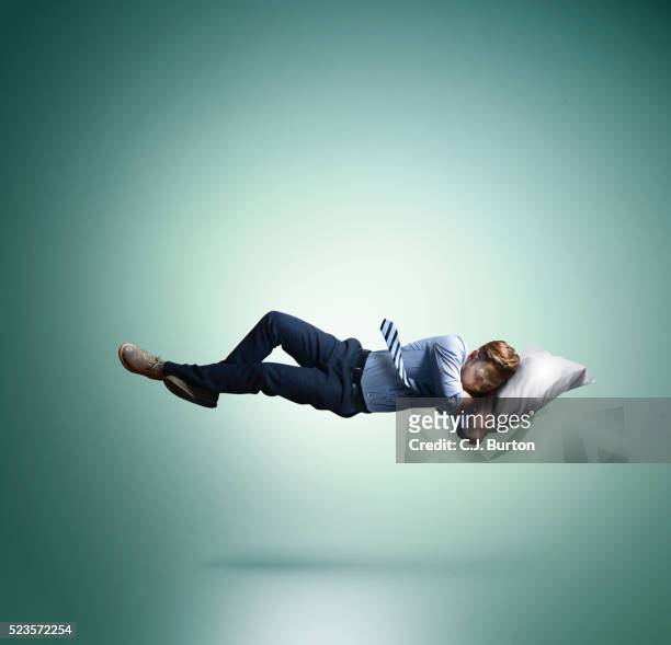 man floating in mid-air, sleeping - man sleeping pillow stock-fotos und bilder