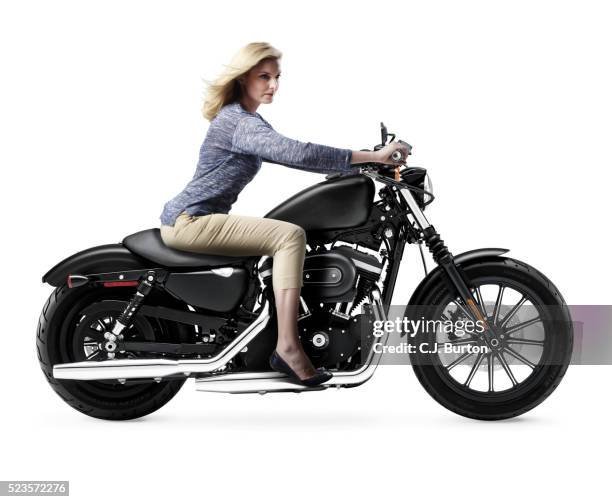 studio shot of blonde female on black motorbike - women black and white motorcycle fotografías e imágenes de stock