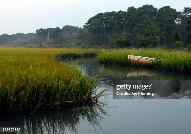 chesapeake bay workboat in marsh creek - chesapeake bay stock pictures, royalty-free photos & images