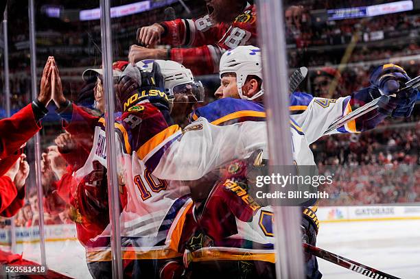 Scottie Upshall and Steve Ott of the St. Louis Blues react after Upshall scored against the Chicago Blackhawks in the first period of Game Six of the...