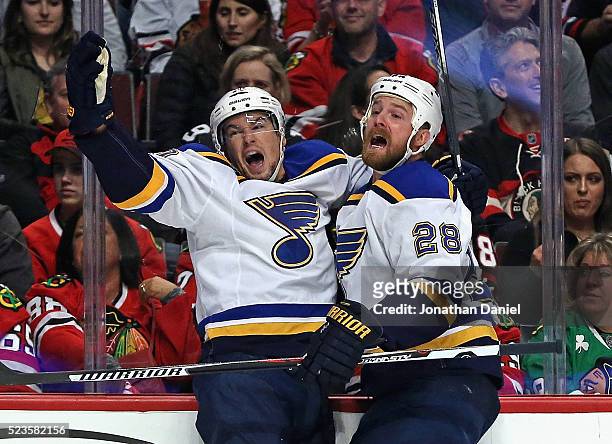 Scottie Upshall and Kyle Brodziak of the St. Louis Blues celebrate Upshall's first period goal against the Chicago Blackhawks in Game Six of the...