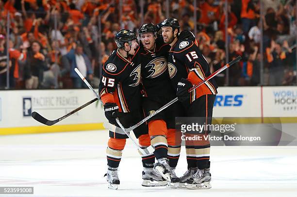 Sami Vatanen, Cam Fowler and Ryan Getzlaf of the Anaheim Ducks celebrate Fowler's power-play goal at center ice in the third period of Game Five of...