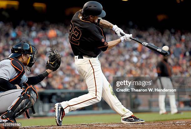 Jake Peavy of the San Francisco Giants hits a bases loaded two-run rbi single against the Miami Marlins in the bottom of the fourth inning at AT&T...
