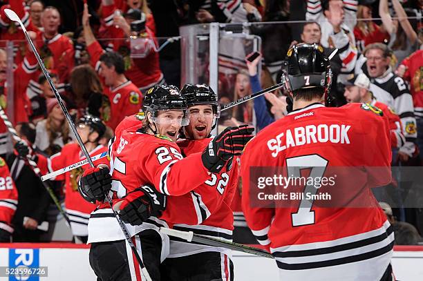 Dale Weise and Erik Gustafsson of the Chicago Blackhawks react after Weise scored against the St. Louis Blues to give the Blackhawks the lead in the...