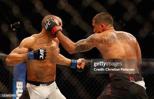 Anthony Pettis punches Edson Barboza in their lightweight bout during the UFC 197 event inside MGM Grand Garden Arena on April 23, 2016 in Las Vegas,...