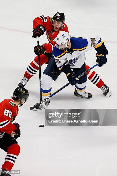 Jonathan Toews of the Chicago Blackhawks and Troy Brouwer of the St. Louis Blues battle for the puck in the third period of Game Six of the Western...