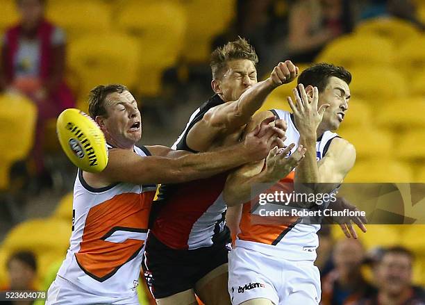 Sam Fisher of the Saints is challenged by Steve Johnson and Jeremy Cameron of the Giants during the round five AFL match between the St Kilda Saints...