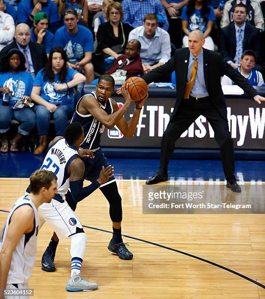 Dallas Mavericks head coach Rick Carlisle uses body language as he watches guard Wesley Matthews defend the Oklahoma City Thunder's Kevin Durant in...