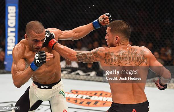 Anthony Pettis punches Edson Barboza in their lightweight bout during the UFC 197 event inside MGM Grand Garden Arena on April 23, 2016 in Las Vegas,...