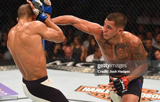 Anthony Pettis punches Edson Barboza in their lightweight bout during the UFC 197 event inside MGM Grand Garden Arena on April 23, 2016 in Las Vegas,...