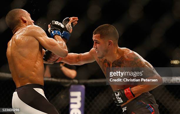 Anthony Pettis punches Edson Barboza in their lightweight bout during the UFC 197 event inside MGM Grand Garden Arena on April 23, 2016 in Las Vegas,...