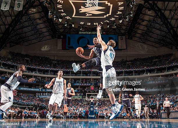 Russell Westbrook of the Oklahoma City Thunder goes in for the layup against Dirk Nowitzki of the Dallas Mavericks in Game Four of the Western...