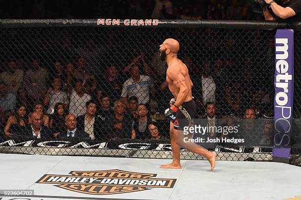 Demetrious Johnson celebrates his TKO victory over Henry Cejudo in their flyweight championship bout during the UFC 197 event inside MGM Grand Garden...