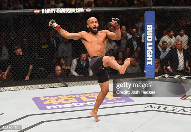 Demetrious Johnson celebrates his TKO victory over Henry Cejudo in their flyweight championship bout during the UFC 197 event inside MGM Grand Garden...