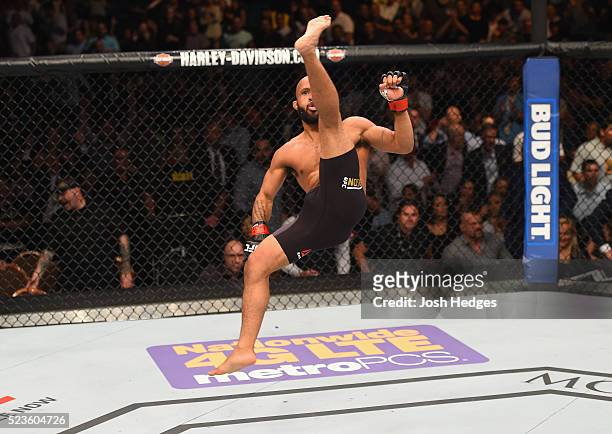 Demetrious Johnson celebrates his TKO victory over Henry Cejudo in their flyweight championship bout during the UFC 197 event inside MGM Grand Garden...