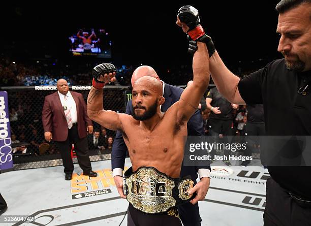 Demetrious Johnson celebrates his TKO victory over Henry Cejudo in their flyweight championship bout during the UFC 197 event inside MGM Grand Garden...