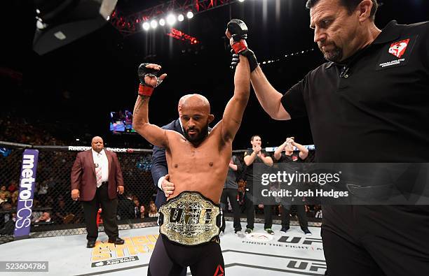 Demetrious Johnson celebrates his TKO victory over Henry Cejudo in their flyweight championship bout during the UFC 197 event inside MGM Grand Garden...