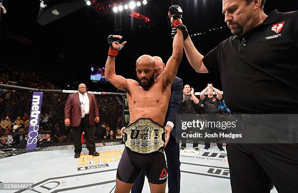 Demetrious Johnson celebrates his TKO victory over Henry Cejudo in their flyweight championship bout during the UFC 197 event inside MGM Grand Garden...