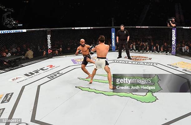 Demetrious Johnson kicks Henry Cejudo in their flyweight championship bout during the UFC 197 event inside MGM Grand Garden Arena on April 23, 2016...