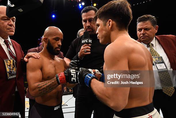 Demetrious Johnson and Henry Cejudo touch gloves before their flyweight championship bout during the UFC 197 event inside MGM Grand Garden Arena on...