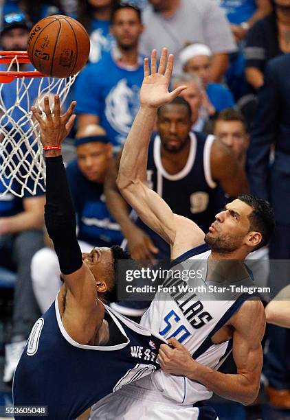 The Dallas Mavericks' Salah Mejri pulls on the jersey of the Oklahoma City Thunder's Russell Westbrook as he shoots in the third period during Game 4...