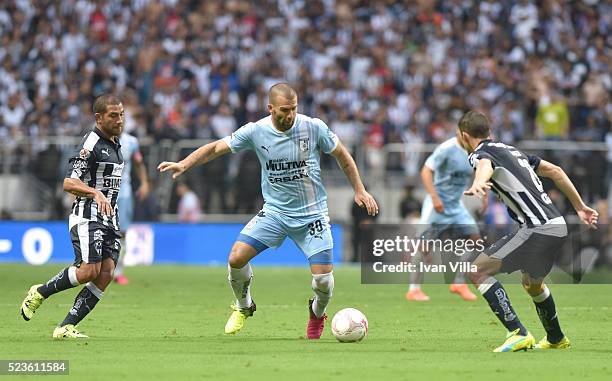 Emanuel Villa of Monterrey drives the ball as he faces the mar of Walter Gargano and Hiram Mier of Monterrey during the 15th round match between...