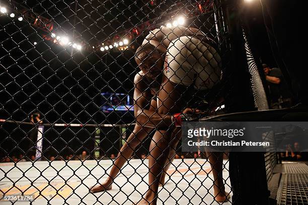 Jon Jones clinches with Ovince Saint Preux in their interim UFC light heavyweight championship bout during the UFC 197 event inside MGM Grand Garden...