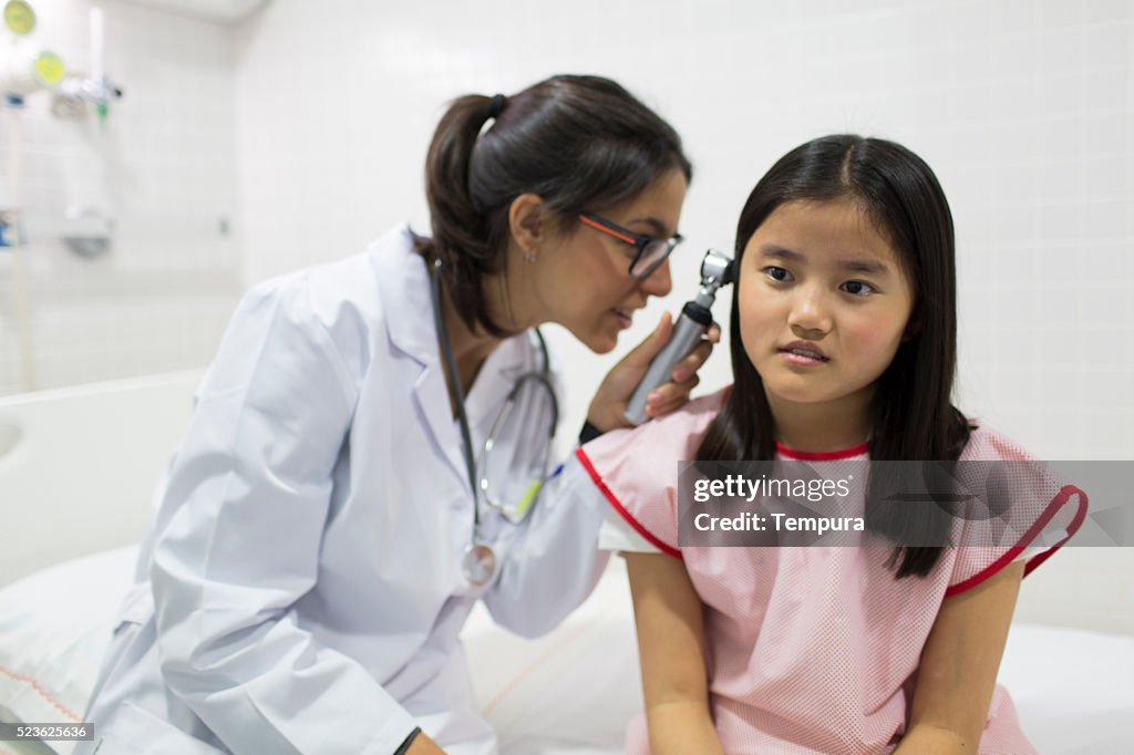 Paediatrician with asian girl at the hospital.