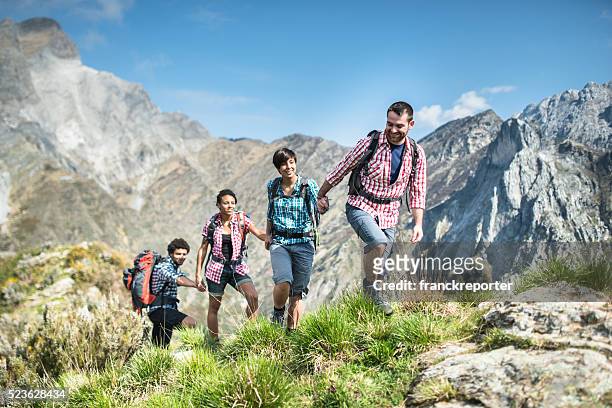 group of people hiking the mountain togetherness - team climbing up to mountain top stock pictures, royalty-free photos & images