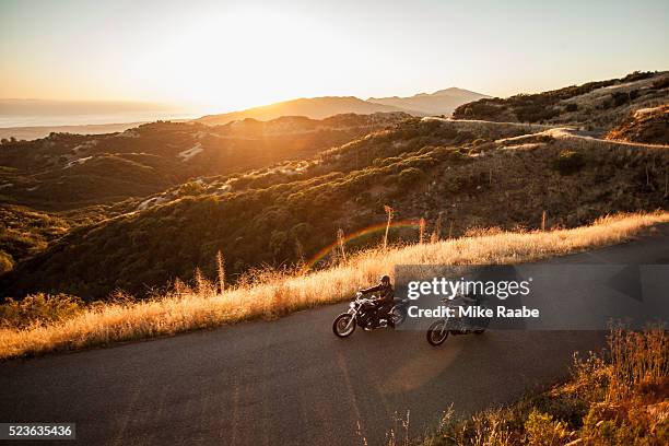 two friends riding motorcycles together on country roads, santa barbara county, california, usa - sunset barbara stock-fotos und bilder