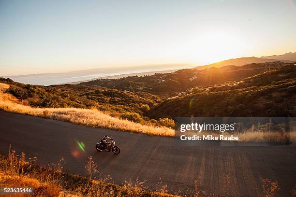 man riding motorcycle on country roads, santa barbara county, california, usa - sunset barbara stock-fotos und bilder