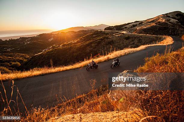 two friends riding motorcycles together on country roads, santa barbara county, california, usa - サンタイネス ストックフォトと画像
