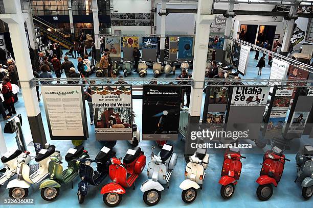 People attend the exhibition for the celebration of 70 years of the scooter Vespa in the Piaggio museum on April 23, 2016 in Pontedera, Italy. Vespa...
