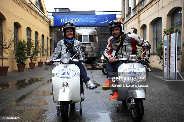 Two scooter riders beloging to the 'Vespa Club Pontedera' poses for a photo during the exhibition for the celebration of 70 years of the scooter...