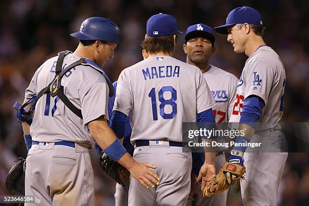 Starting pitcher Kenta Maeda of the Los Angeles Dodgers is sent off the mound by manager manager Dave Roberts and teammates A.J. Ellis, Chase Utley...