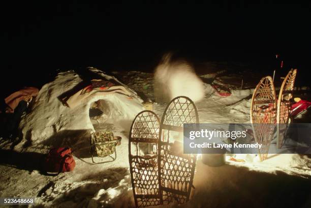 snowshoes and igloo around campfire - boundary waters canoe area stock pictures, royalty-free photos & images