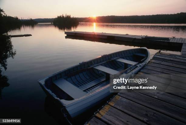 sunrise behind rowboat and dock - isle royale national park - fotografias e filmes do acervo