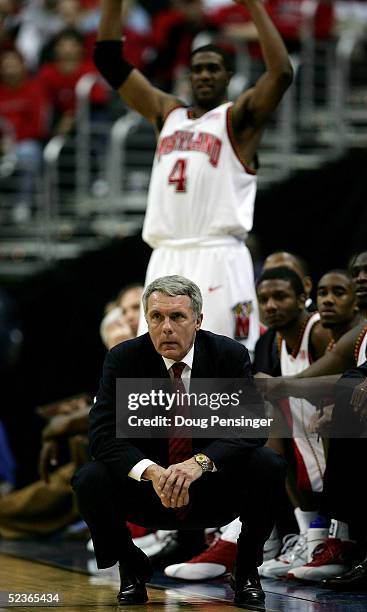Head coach Gary Williams of Maryland watches as Travis Garrison stands up behind him during their first round ACC Tournament game against Clemson at...