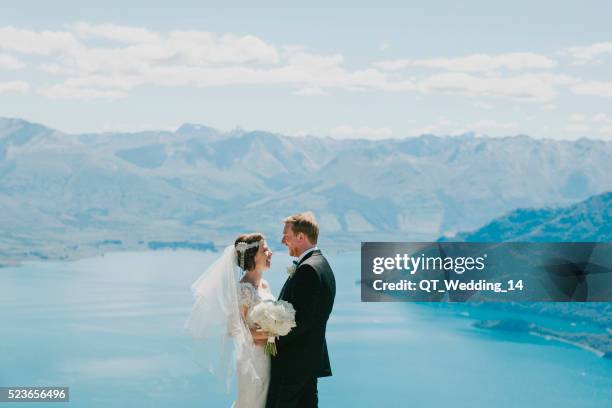 wedding couple above lake wakatipu, queenstown, new zealand - couple archival stock pictures, royalty-free photos & images