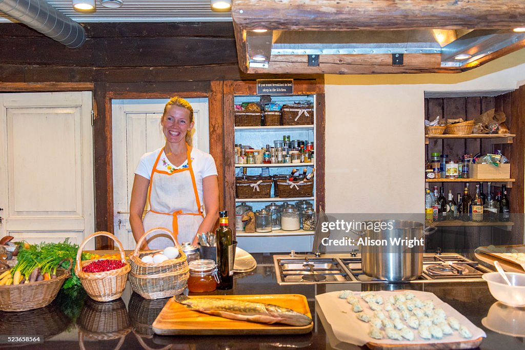 Estonia, Muhu Island. Muhu Jaanalind, guest house and farm. Ingrem Raidjoe (Daughter & owner), cooking lunch.