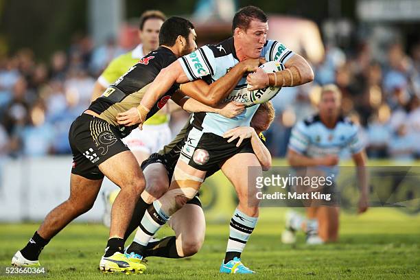 Paul Gallen of the Sharks is tackled during the round eight NRL match between the Cronulla Sharks and the Penrith Panthers at Southern Cross Group...